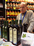 Vasilios Contis offering samples of olives and olive oil at a tasting
